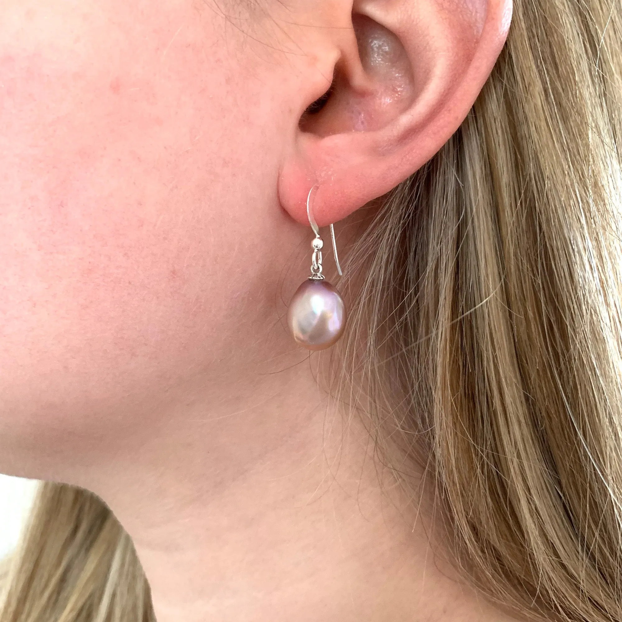 Pearl earrings with large freshwater natural purple baroque near oval pearl drops on silver hooks